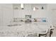 Kitchen boasts white cabinets, granite countertops, stainless steel appliances and a large center island at 789 Goodman Cove St, Henderson, NV 89011