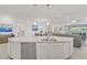 Open concept kitchen featuring a large island with granite countertops, stainless appliances, and a view to living areas at 789 Goodman Cove St, Henderson, NV 89011