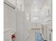 Laundry room with a washer, dryer, storage cabinets, and tile floor at 789 Goodman Cove St, Henderson, NV 89011