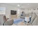 Spacious living room featuring a large sofa, modern ceiling fan and stylish decor at 789 Goodman Cove St, Henderson, NV 89011