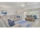 Bright and airy living room with a comfortable sectional sofa, neutral tones, and an adjacent bar area at 789 Goodman Cove St, Henderson, NV 89011