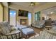 Relaxing living room space with a fireplace, sofas, ottomans, and ceiling fan at 789 Goodman Cove St, Henderson, NV 89011