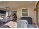 Inviting covered patio features cozy seating, a ceiling fan, and outdoor cooking area with covered grills at 789 Goodman Cove St, Henderson, NV 89011