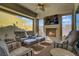 Comfortable covered patio with ample seating, tv, and cozy fireplace at 789 Goodman Cove St, Henderson, NV 89011