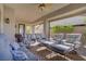 Inviting covered patio featuring ample seating, a ceiling fan, and views of the landscaped backyard at 789 Goodman Cove St, Henderson, NV 89011