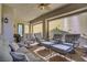 Relaxing covered patio with plush seating arrangements, ceiling fan and sunshades for comfortable outdoor living at 789 Goodman Cove St, Henderson, NV 89011