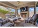 Comfortable covered patio with ample seating, tv, and cozy fireplace at 789 Goodman Cove St, Henderson, NV 89011