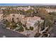Aerial view of a luxurious home with lush landscaping and a circular driveway in a gated community at 8109 Moonstone Cir, Las Vegas, NV 89128