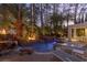 Stunning backyard pool and spa area with rock features and an outdoor kitchen in a tropical setting at 8109 Moonstone Cir, Las Vegas, NV 89128
