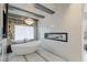 Relaxing bathroom featuring a stand-alone tub, modern fixtures, and a built-in fireplace at 8109 Moonstone Cir, Las Vegas, NV 89128
