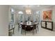 Elegant dining room with large round table, stylish chandelier, and decorative wallpaper at 8109 Moonstone Cir, Las Vegas, NV 89128