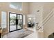 Bright foyer with a statement staircase, large windows, and elegant chandelier at 8109 Moonstone Cir, Las Vegas, NV 89128