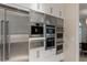 Modern kitchen with stainless steel appliances and sleek white cabinets at 8109 Moonstone Cir, Las Vegas, NV 89128