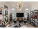 Unique living room with entertainment setup, natural light, and hardwood flooring at 8109 Moonstone Cir, Las Vegas, NV 89128