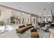Expansive living area with a large sofa, stylish decor, and seamless flow to the kitchen at 8109 Moonstone Cir, Las Vegas, NV 89128
