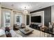 Stylish living room featuring a modern chandelier, sleek entertainment setup and bar area at 8109 Moonstone Cir, Las Vegas, NV 89128