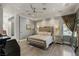 Spacious main bedroom with a geometric headboard, mirrored nightstands, and hardwood floors at 8109 Moonstone Cir, Las Vegas, NV 89128