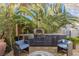Outdoor kitchen with pizza oven, stainless steel appliances, and patio seating area at 8109 Moonstone Cir, Las Vegas, NV 89128