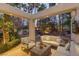 Inviting outdoor living space with comfortable seating, a covered patio, and lush tropical landscaping at 8109 Moonstone Cir, Las Vegas, NV 89128