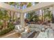 Inviting outdoor patio with comfortable seating, a water feature, and tropical foliage at 8109 Moonstone Cir, Las Vegas, NV 89128