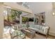 Relaxing outdoor patio with comfortable seating, a tv, and lush greenery views at 8109 Moonstone Cir, Las Vegas, NV 89128