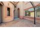 Enclosed back patio area with custom stonework, arched windows, and arched entry at 853 Ashford Way, Henderson, NV 89015