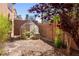 Serene backyard featuring a small greenhouse with an AC unit and brick fencing at 853 Ashford Way, Henderson, NV 89015