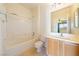 Well-lit bathroom features a bathtub, vanity, and tiled floor at 853 Ashford Way, Henderson, NV 89015