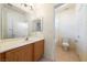 Bright bathroom featuring a single sink vanity and a separate toilet and tub area at 853 Ashford Way, Henderson, NV 89015