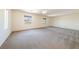 Spacious primary bedroom with carpet flooring and natural light from two windows at 853 Ashford Way, Henderson, NV 89015