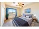 Stylishly decorated bedroom with a large bed, ceiling fan, and bright window at 853 Ashford Way, Henderson, NV 89015