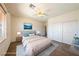 Staged bedroom with a large window, ceiling fan, and double door closet for ample storage at 853 Ashford Way, Henderson, NV 89015
