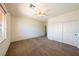 Spacious bedroom with a large window, ceiling fan, and double door closet for ample storage at 853 Ashford Way, Henderson, NV 89015