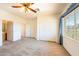 Bright and airy bedroom with carpet, ceiling fan, and a closet and en-suite bath at 853 Ashford Way, Henderson, NV 89015