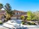 Two-story home with three-car garage, well-maintained landscaping and mature shade trees at 853 Ashford Way, Henderson, NV 89015