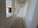 Hallway with architectural cutouts offers glimpses into the adjacent living spaces with natural light at 853 Ashford Way, Henderson, NV 89015