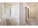 Bright hallway with neutral walls and flooring leading to multiple rooms at 853 Ashford Way, Henderson, NV 89015