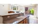 Bright kitchen featuring granite countertops, a large sink, and a pass-through to the living area at 853 Ashford Way, Henderson, NV 89015