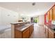 Open floor plan connects kitchen with peninsula island to living room with fireplace at 853 Ashford Way, Henderson, NV 89015