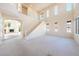 Spacious living room features neutral carpeting and a view of the fireplace at 853 Ashford Way, Henderson, NV 89015