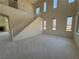 Open floor plan with high ceilings and staircase features natural light and neutral carpet at 853 Ashford Way, Henderson, NV 89015