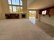 Open-concept living room with fireplace, built-in shelves, tile floors, and ample natural light through large windows at 853 Ashford Way, Henderson, NV 89015