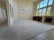 Bright living room with high ceilings, built-in shelving, a fireplace, and large windows providing natural light at 853 Ashford Way, Henderson, NV 89015