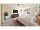 Staged main bedroom featuring neutral tones, a comfortable king-sized bed, and a decorative rug at 853 Ashford Way, Henderson, NV 89015
