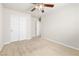 Neutral bedroom with carpet, ceiling fan, and a closet with double doors at 9539 Iris Flat Ct, Las Vegas, NV 89178