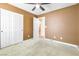 Cozy bedroom with carpet, ceiling fan, window, and closet at 9539 Iris Flat Ct, Las Vegas, NV 89178