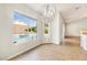 Dining area with decorative chandelier and views of the pool and backyard through large windows at 9539 Iris Flat Ct, Las Vegas, NV 89178