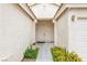 Inviting entryway with a double door, plants, and a decorative light fixture at 9539 Iris Flat Ct, Las Vegas, NV 89178