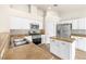 Modern kitchen features white cabinetry, stainless steel appliances, and a convenient center island at 9539 Iris Flat Ct, Las Vegas, NV 89178