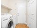 Functional laundry room with modern washer and dryer and extra storage at 9539 Iris Flat Ct, Las Vegas, NV 89178